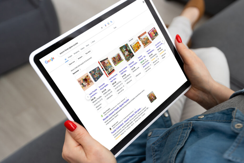 Woman searching for Autumn Florals Jigsaw Puzzles and seeing Stave Puzzles show up first in Google Search results
